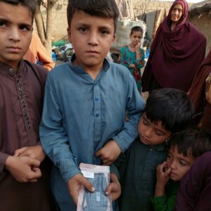 WM Afghan audio Bible distribution_5 Afghan Children holding onto MegaVoice audio Bible
